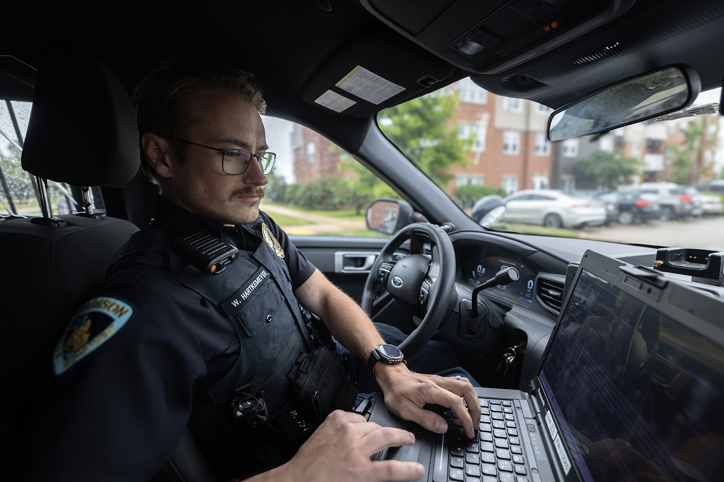 Wesley Hartkemeyer using public safety technology in a patrol vehicle